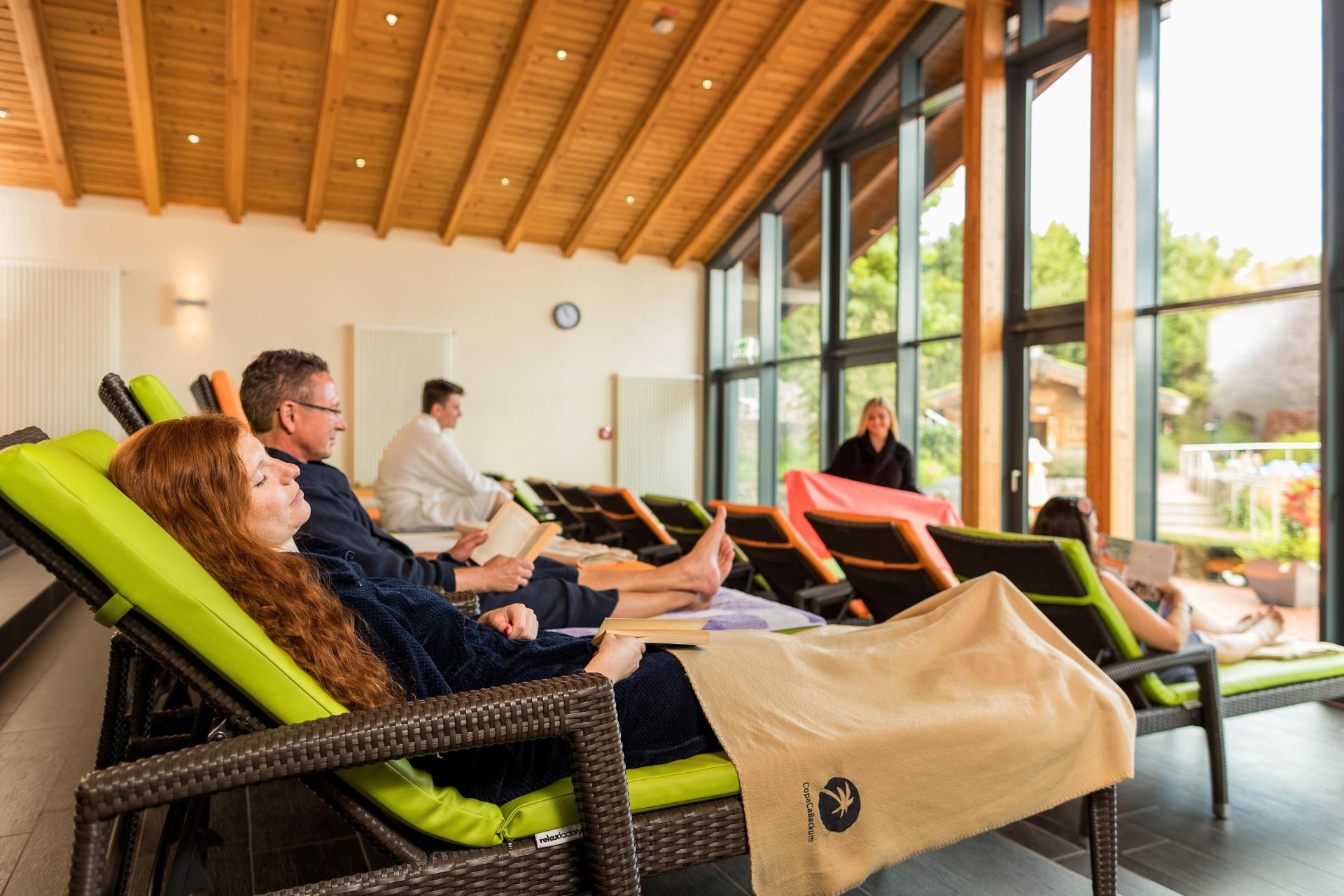 People lounging, enjoying a relaxed atmosphere and natural light.